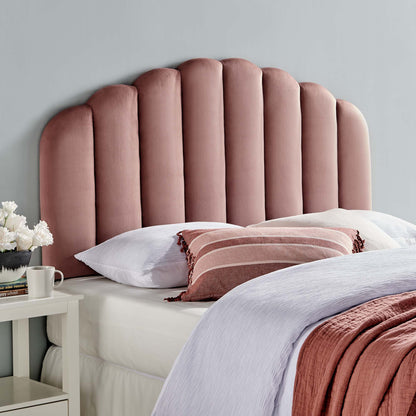 Red velvet scalloped twin headboard with white linens visible.