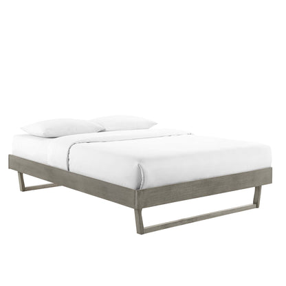 Modern gray wood platform bed with a low sled-style frame and white bedding.