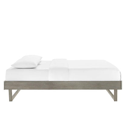 Low-profile gray wood platform bed with white bedding and pillow, minimalist modern design.