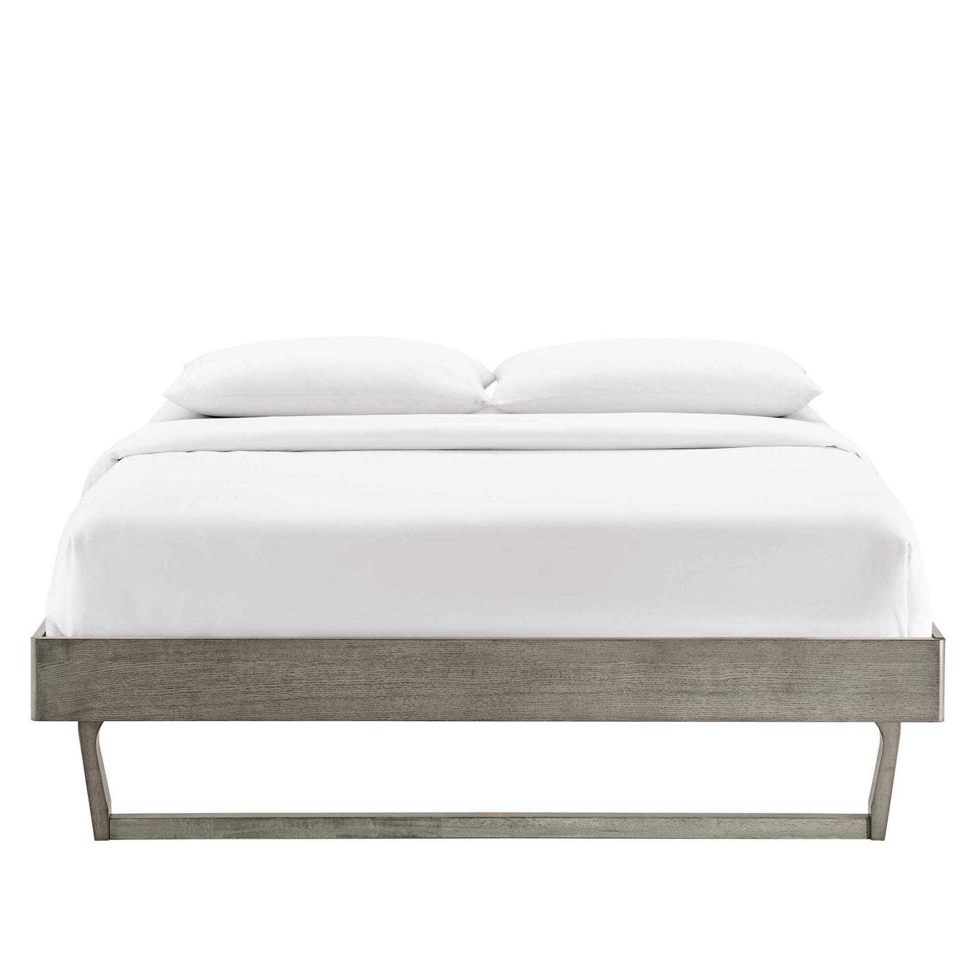 Gray wood platform bed with low-profile frame and angled metal legs, crisp white bedding and two pillows.