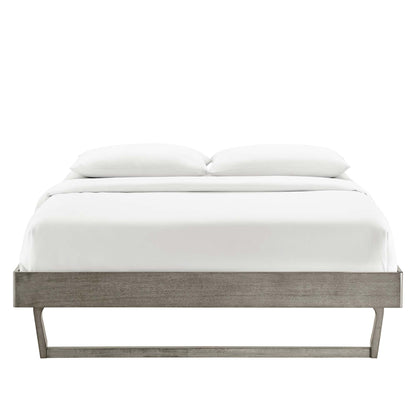 Gray wood platform bed with low-profile frame and angled metal legs, crisp white bedding and two pillows.
