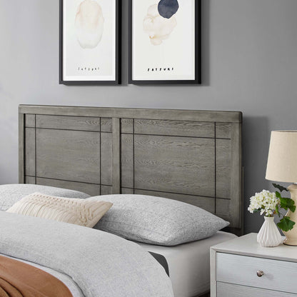 Weathered gray wood headboard with panel details, paired with gray bedding and beige pillow; rustic-modern bedroom.