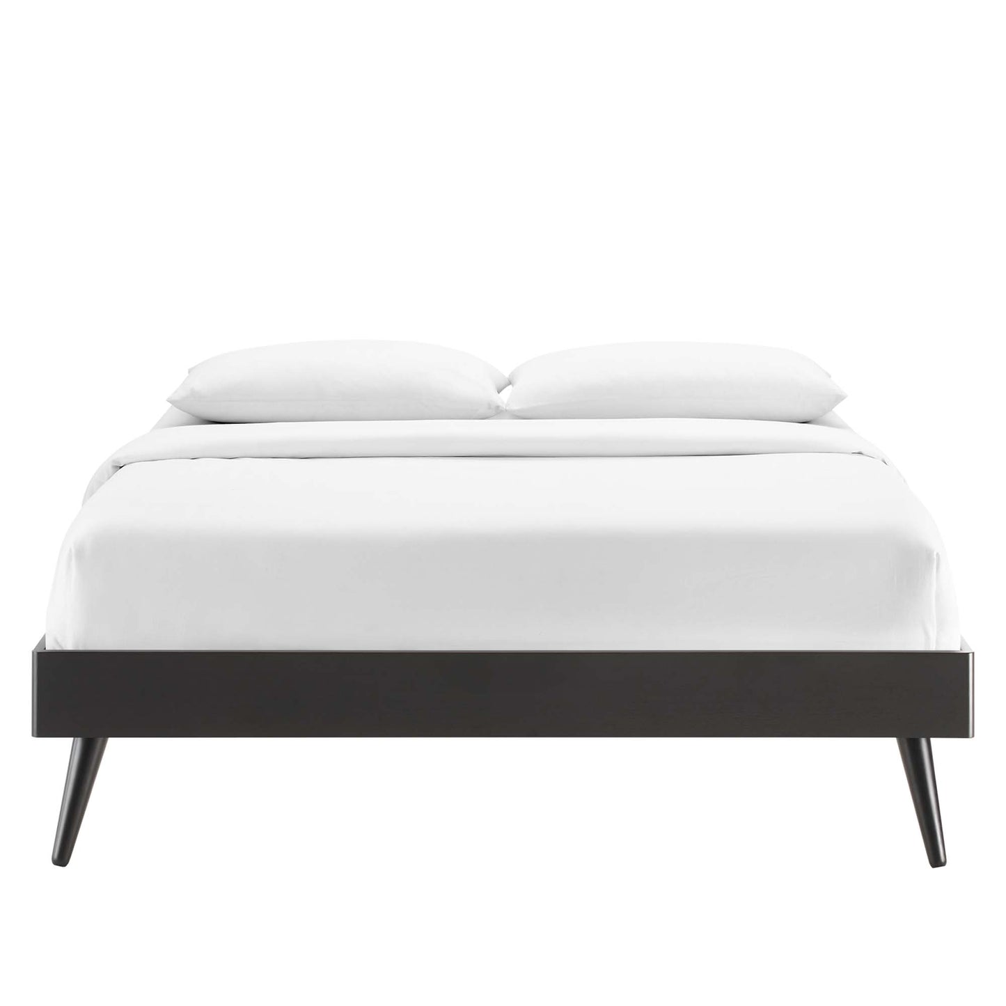 Black platform bed frame with tapered legs & white bedding, modern minimalist design.