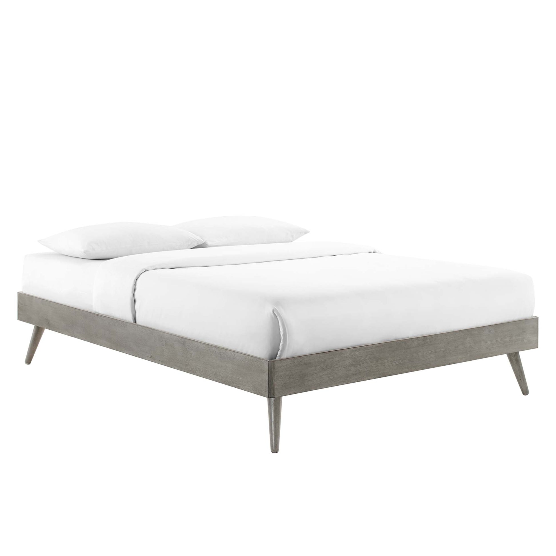 Grey wood platform bed with tapered legs and white bedding.