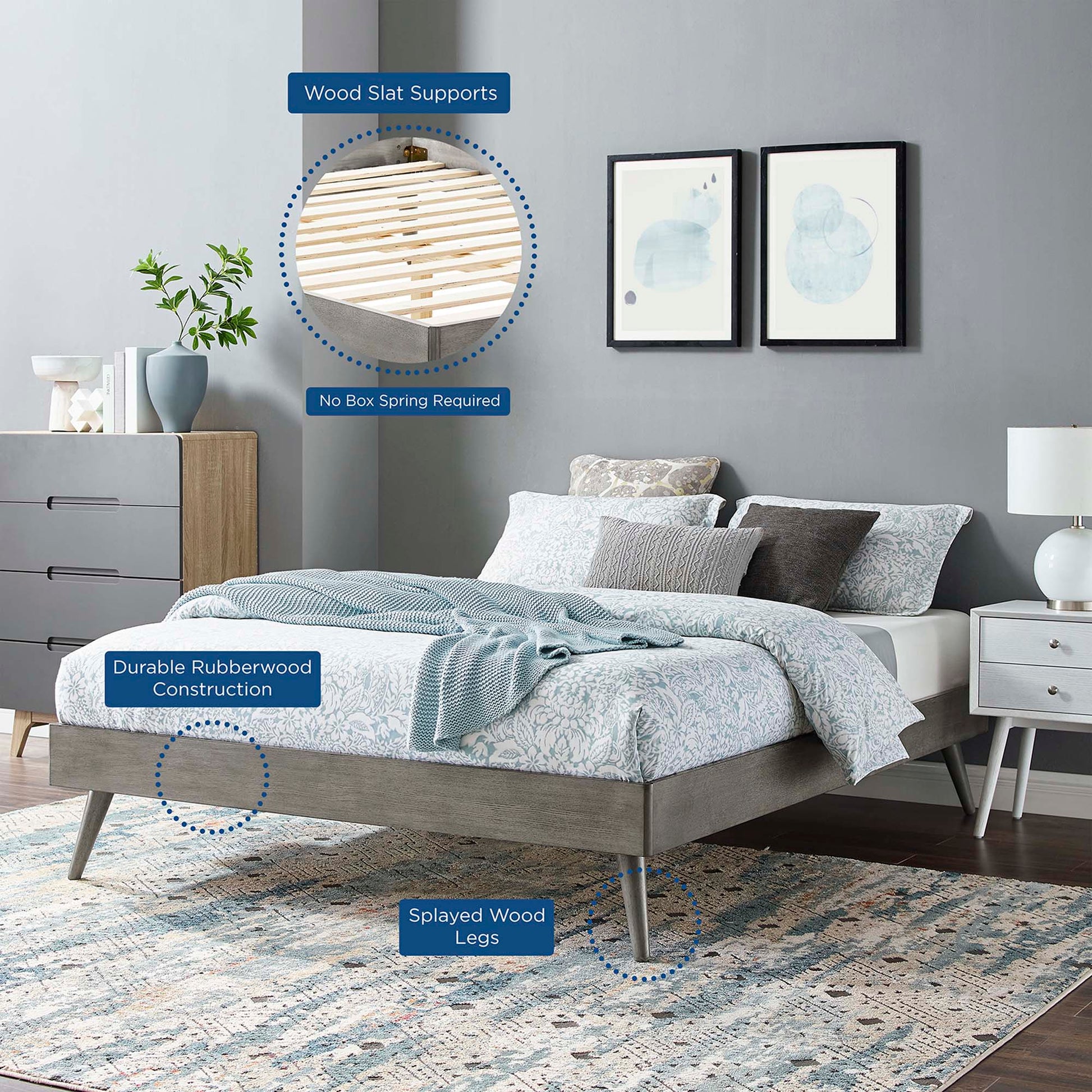 Gray platform bed with rubberwood frame, wood slat supports, splayed wood legs, plus blue patterned bedding and rug.