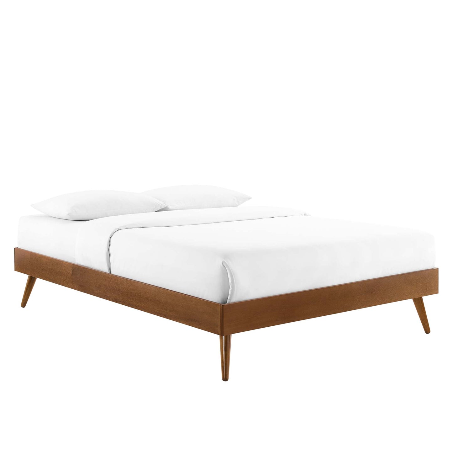 Walnut platform bed with tapered legs in mid-century style, dressed in white bedding with two pillows.