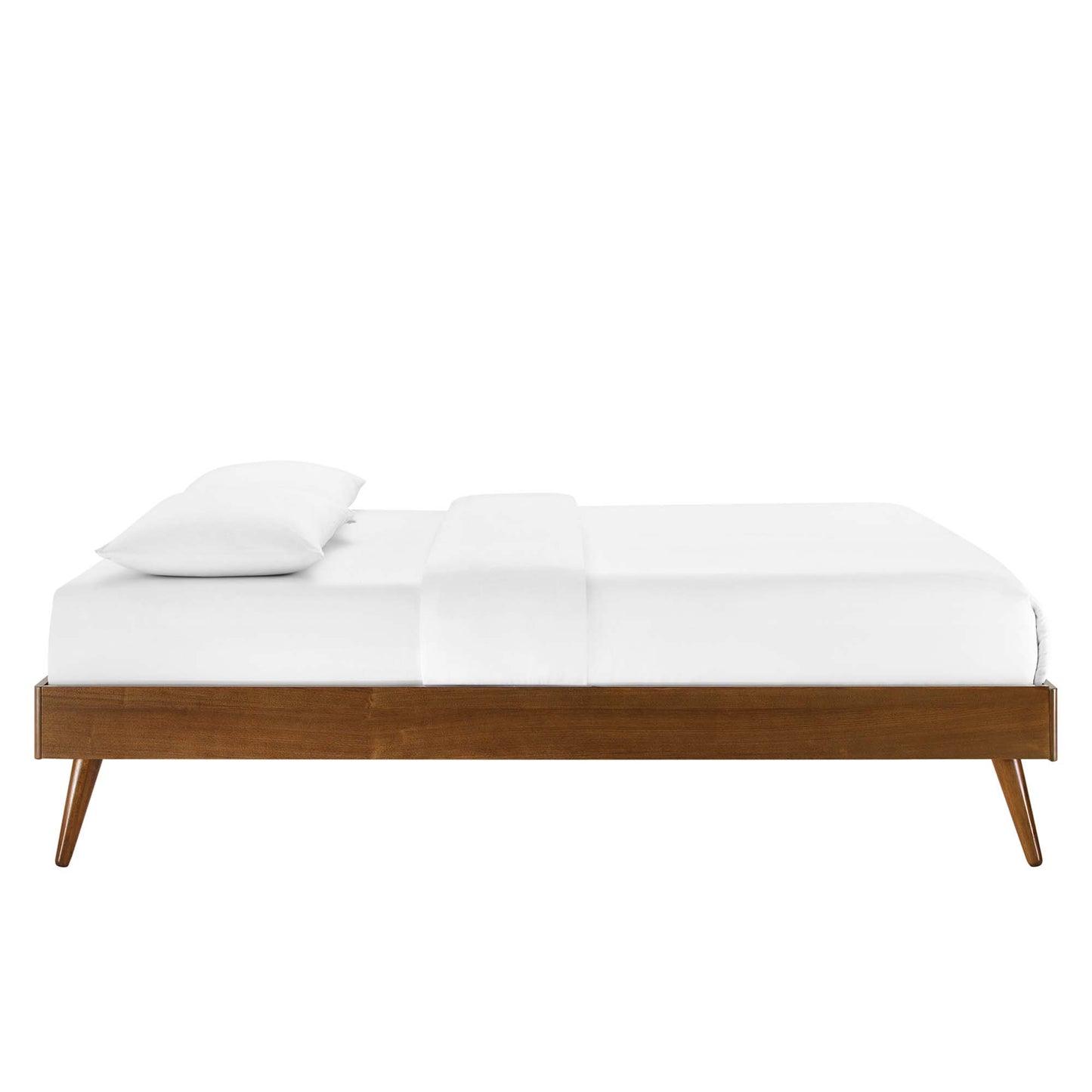 Walnut king platform bed frame with white linens and a single pillow, tapered legs.