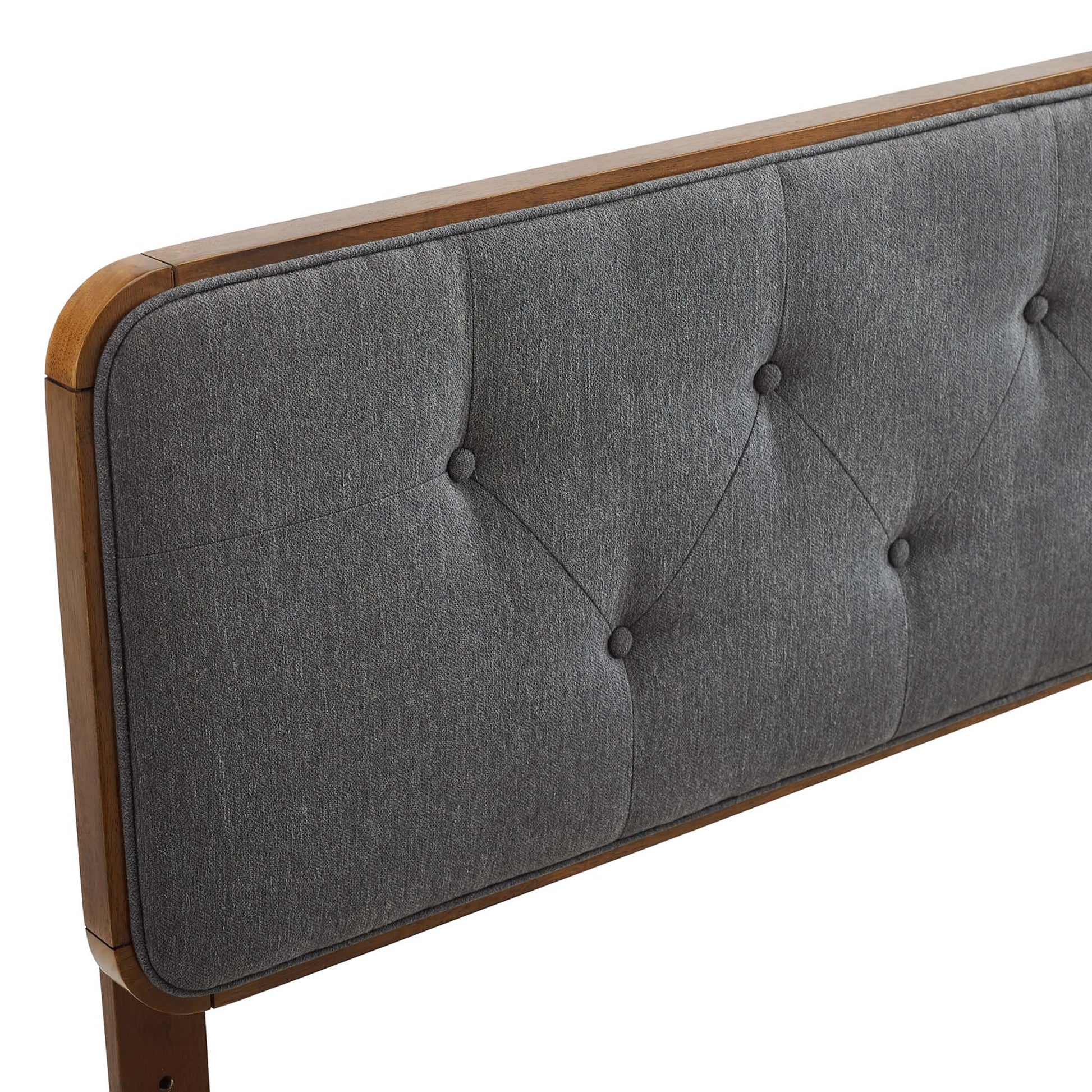 Walnut-wood-framed black tufted fabric headboard with diamond button tufts, mid-century modern style.