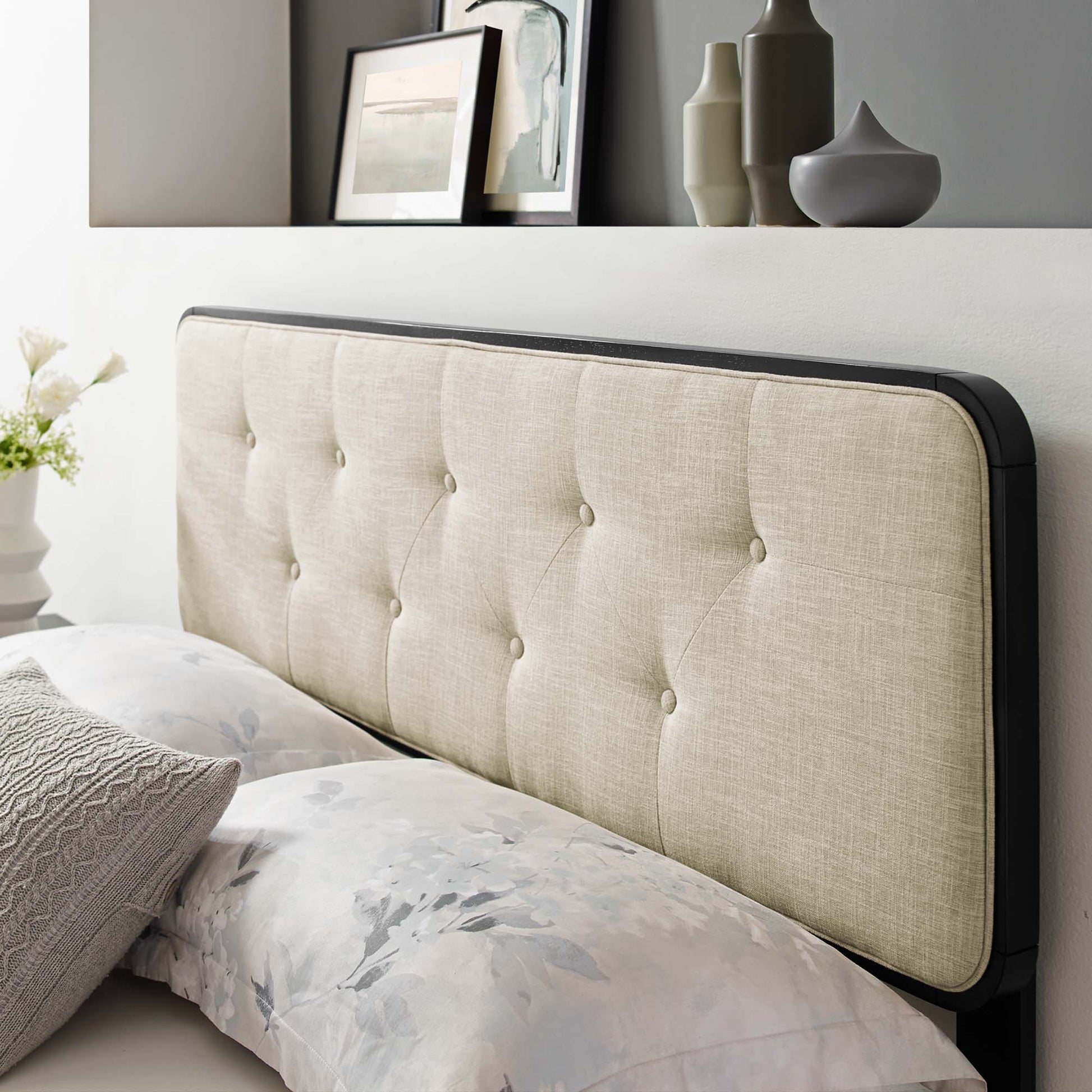 Brown tufted upholstered king headboard with a dark wood edge frame; modern bedroom decor with floral bedding visible.