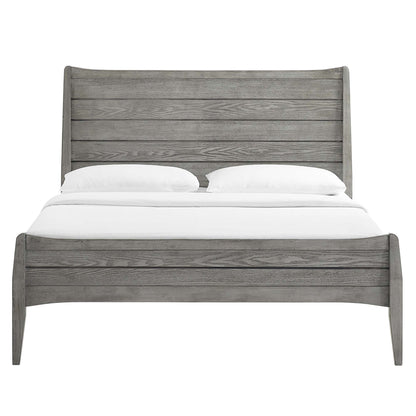Weathered gray wooden bed with tall slatted headboard and curved footboard, rustic farmhouse bedroom centerpiece.