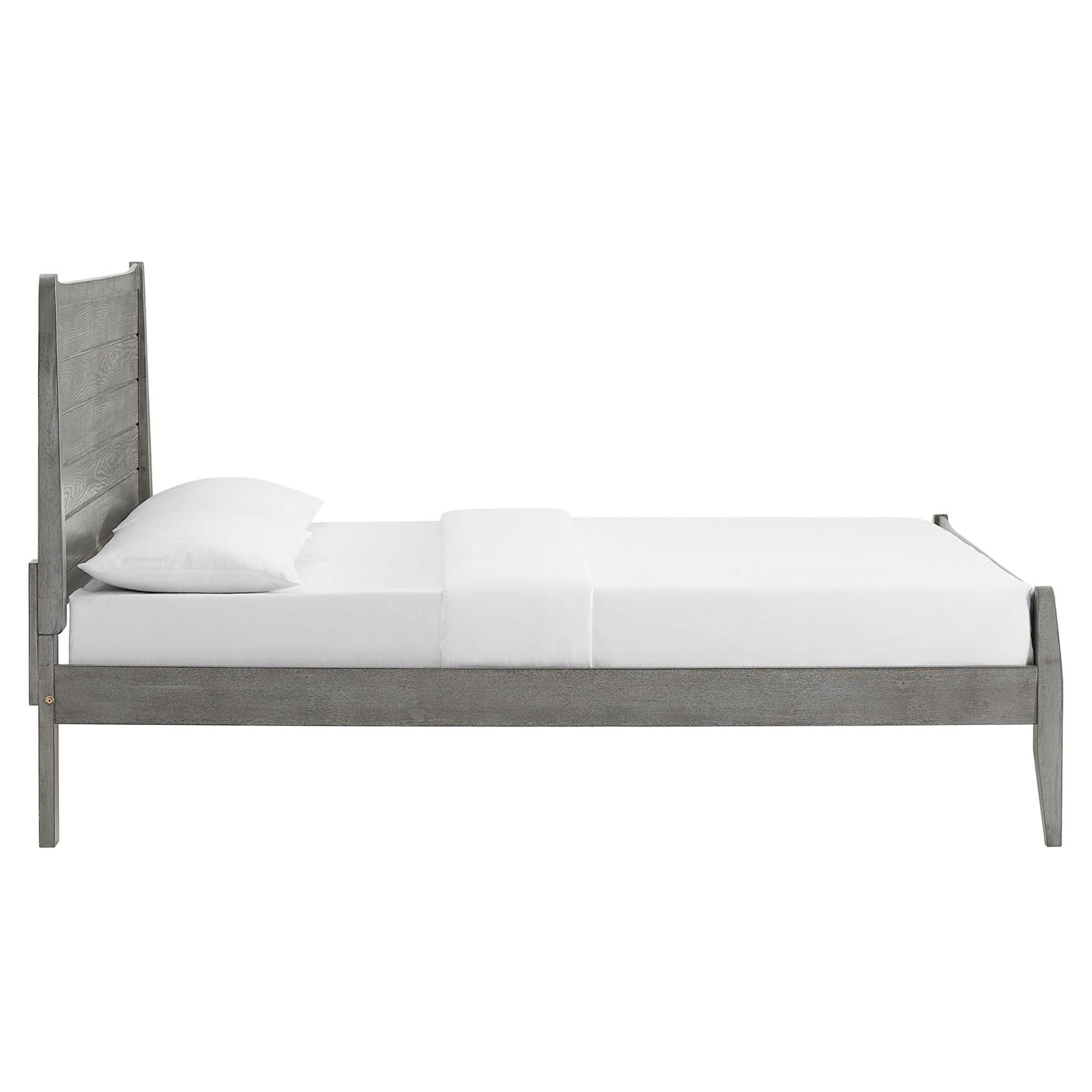 Grey-washed wooden platform bed with a tall paneled headboard, low footboard, and white bedding in a rustic bedroom.