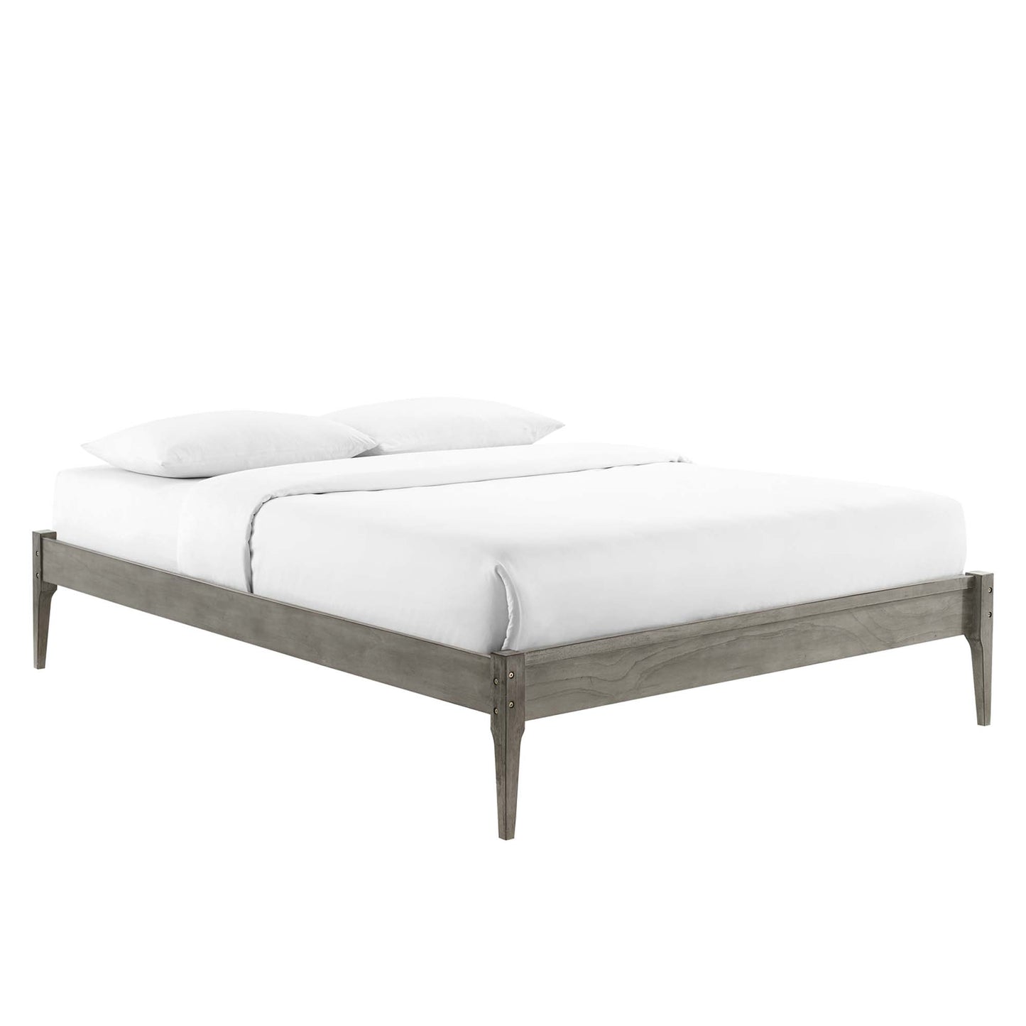 Graywashed wood twin platform bed frame with tapered legs and white bedding.