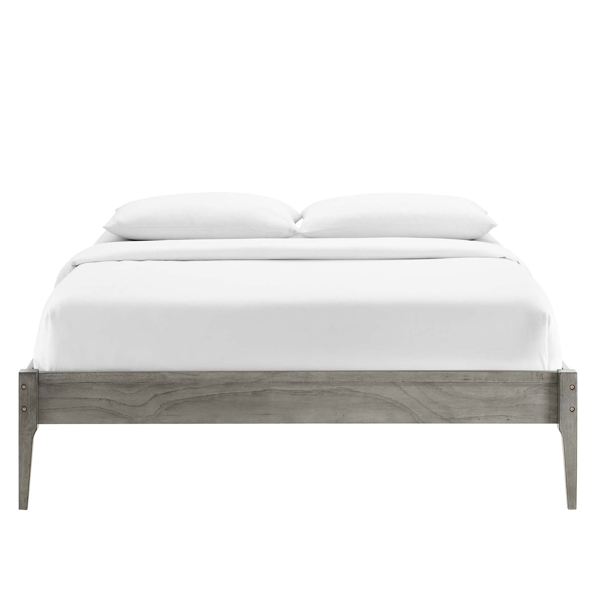Gray-washed wooden platform bed with white bedding and two pillows.