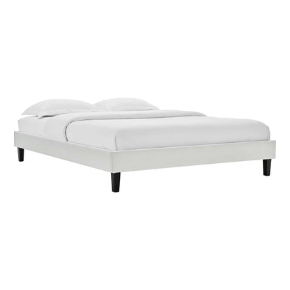 Light gray upholstered platform bed with white bedding, low-profile frame and black tapered legs.