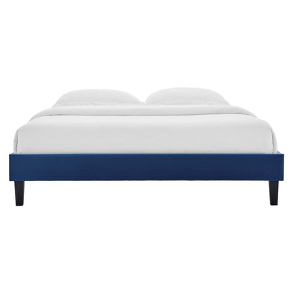 Navy blue platform bed frame with white bedding and two pillows; sleek modern frame with black tapered legs.