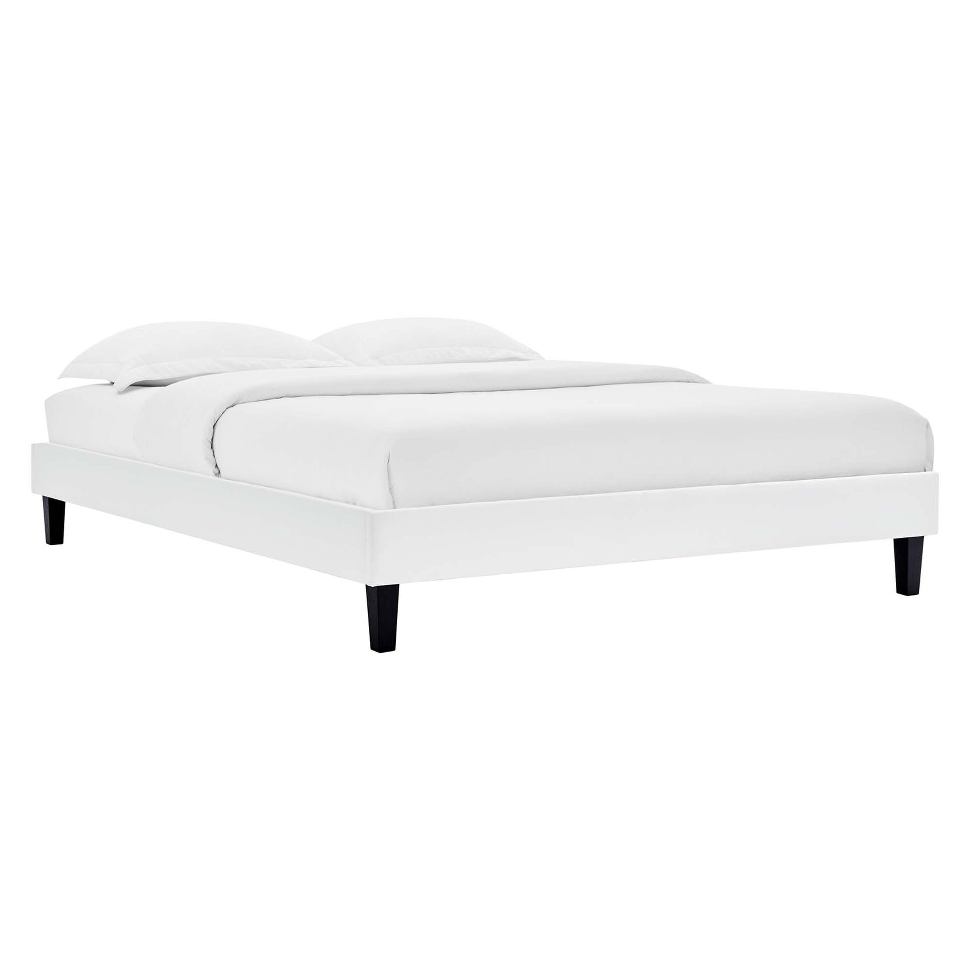 White platform bed with upholstered frame, clean rectangular silhouette, black tapered legs, plush white bedding.