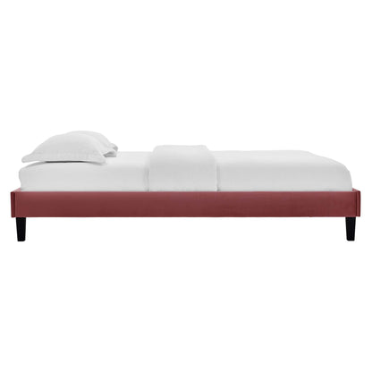 Red velvet queen platform bed with a low-profile frame and white linens.