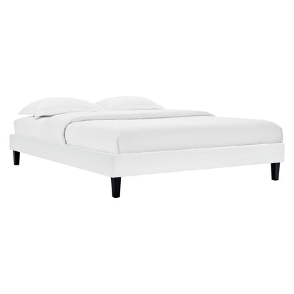 White platform bed with low-profile frame, black tapered legs, and white bedding with two pillows.
