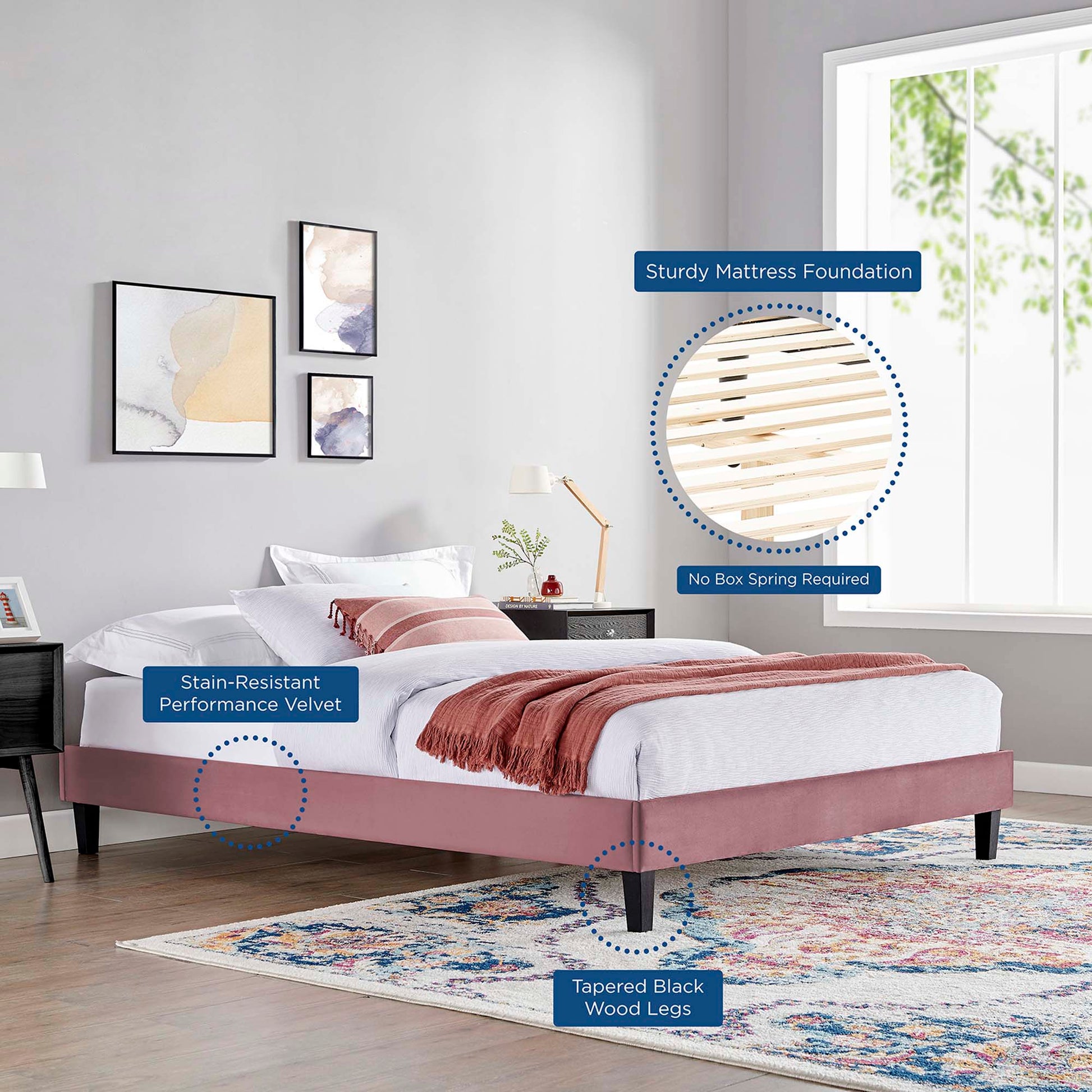 Red velvet king platform bed frame with tapered black wood legs, stain-resistant fabric, white bedding and pink throw.