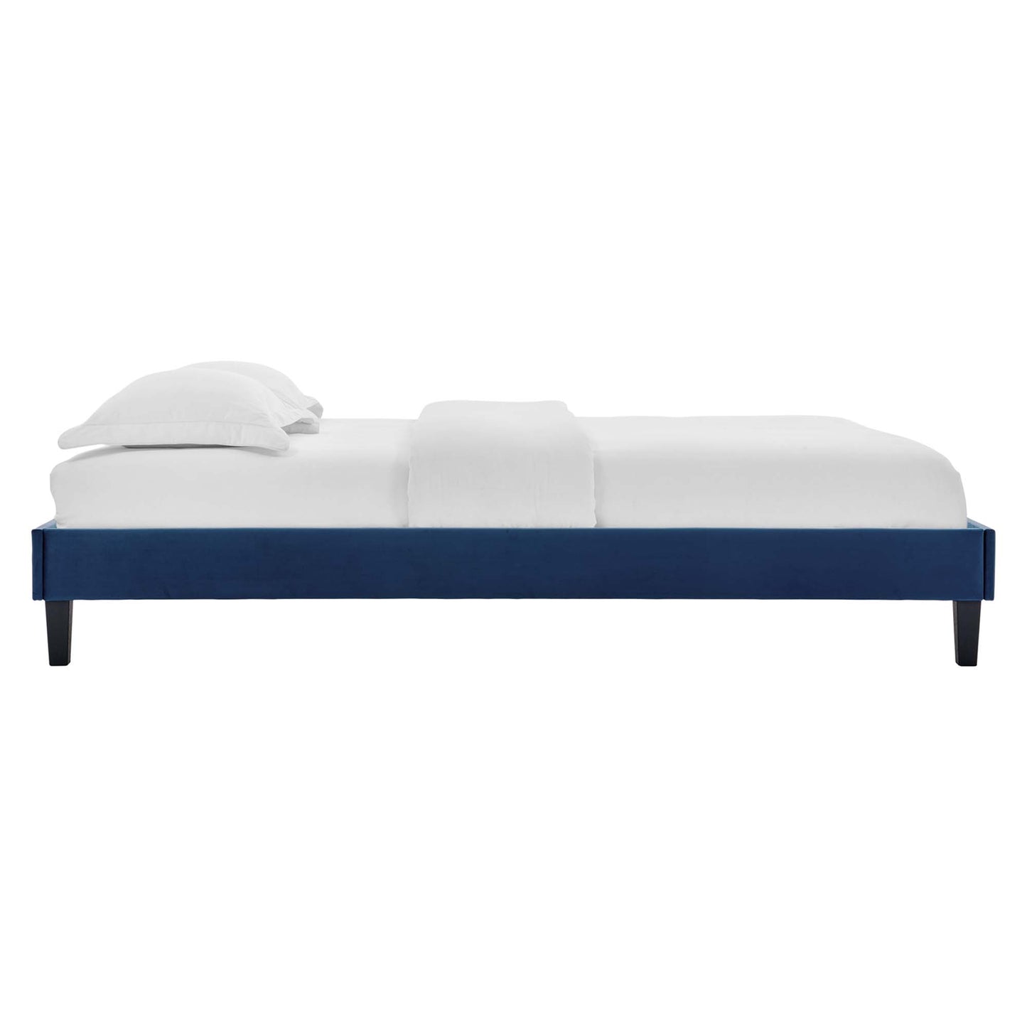 Navy platform bed frame with minimalist low-profile rectangular design, dark tapered legs, and white bedding.