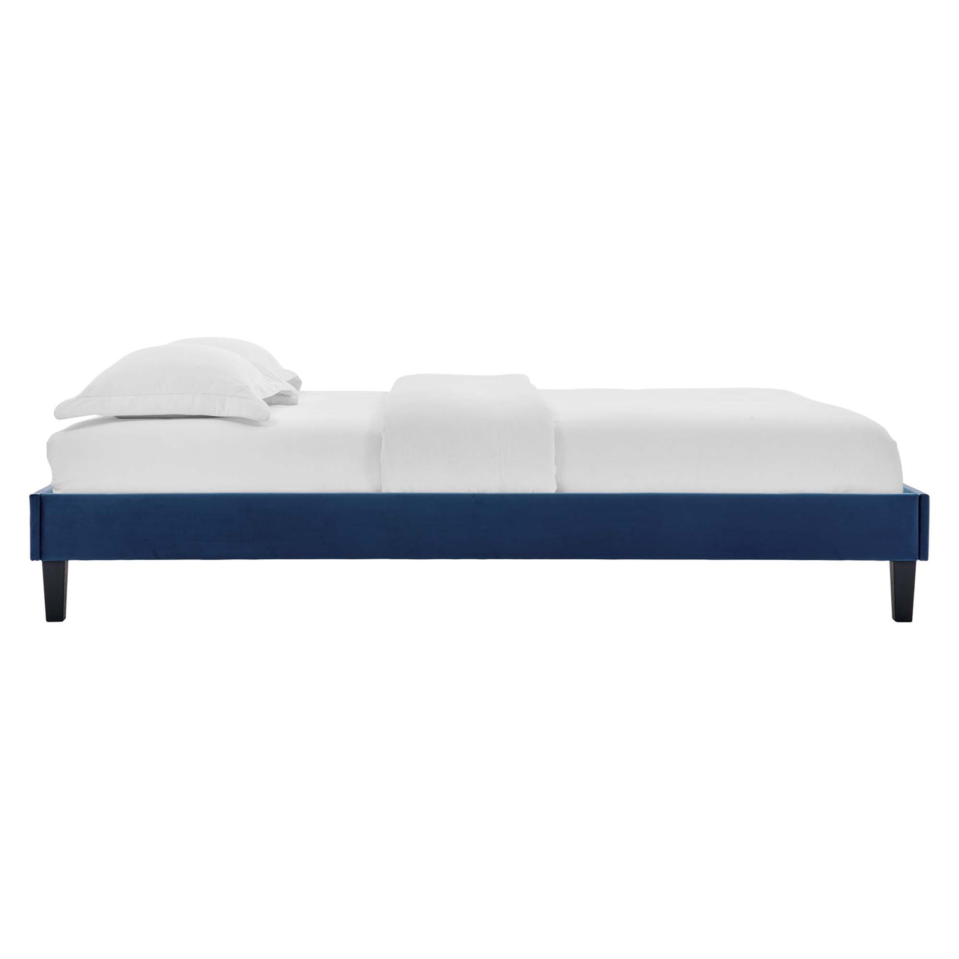 Navy platform bed frame with minimalist low-profile rectangular design, dark tapered legs, and white bedding.