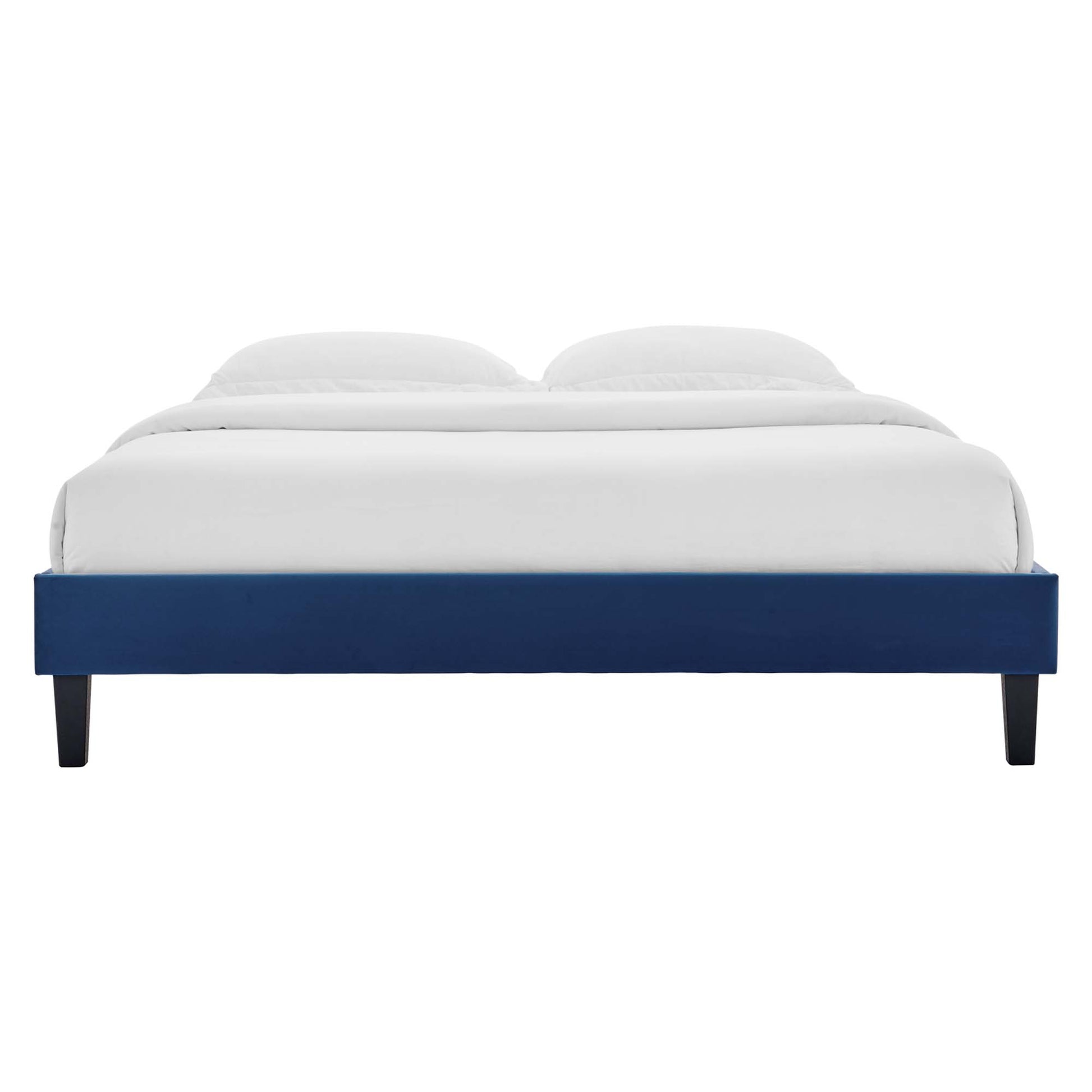 Navy blue low-profile platform bed with white bedding, two pillows, and dark tapered legs.