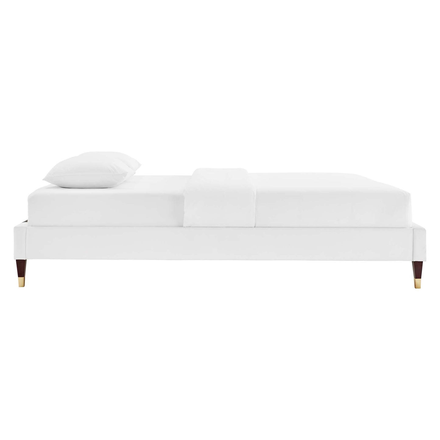 White upholstered twin platform bed frame with tapered wooden legs & brass caps.