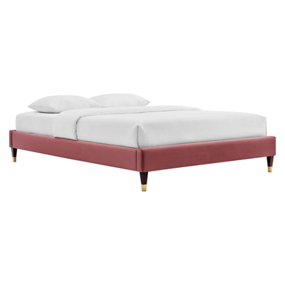 Red velvet low-profile upholstered queen platform bed with gold-tipped legs and white bedding.