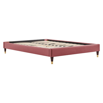 Red velvet platform bed frame with slatted wood base and brass-tipped tapered legs.