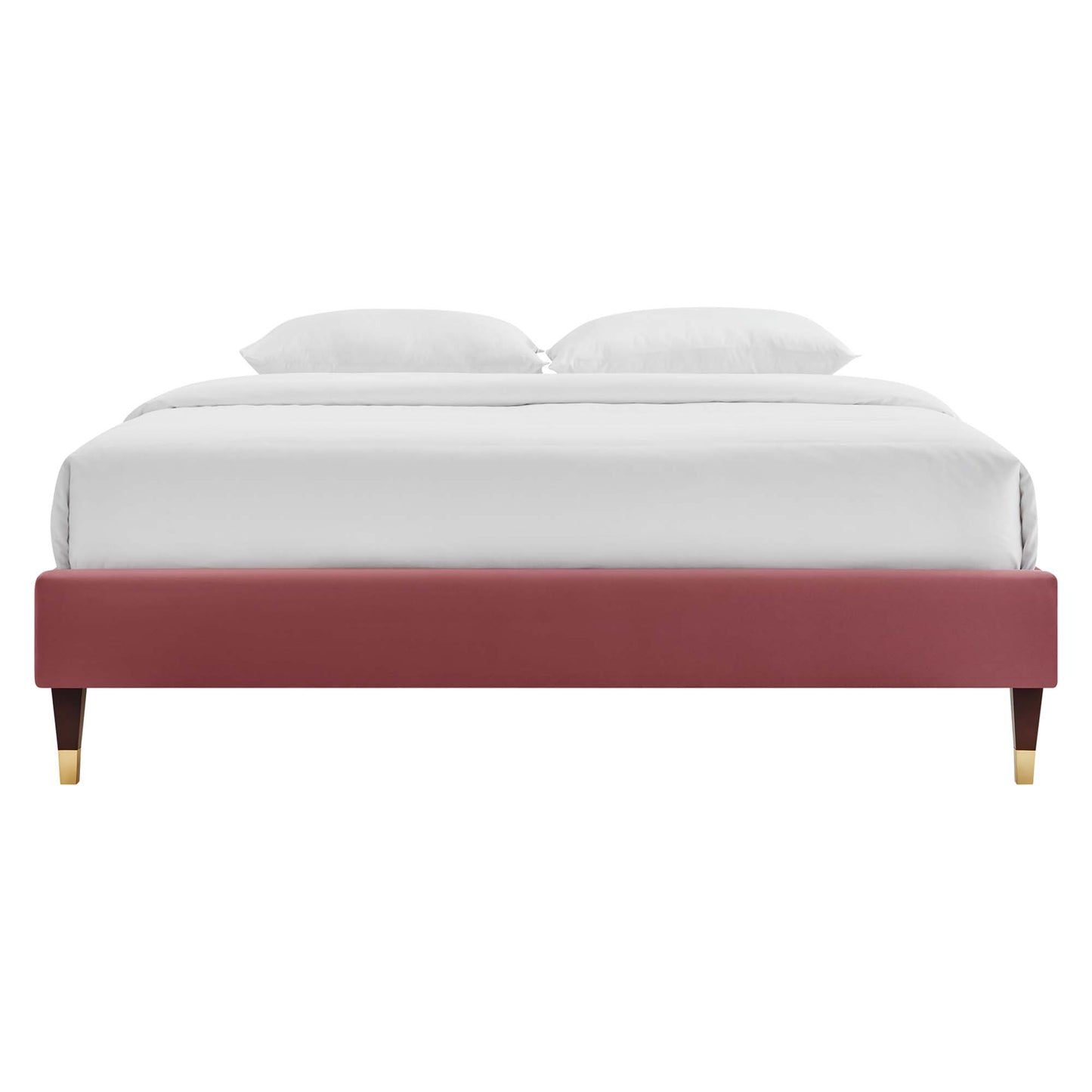 Maroon upholstered platform bed with gold-tipped wooden legs, white bedding and two pillows.