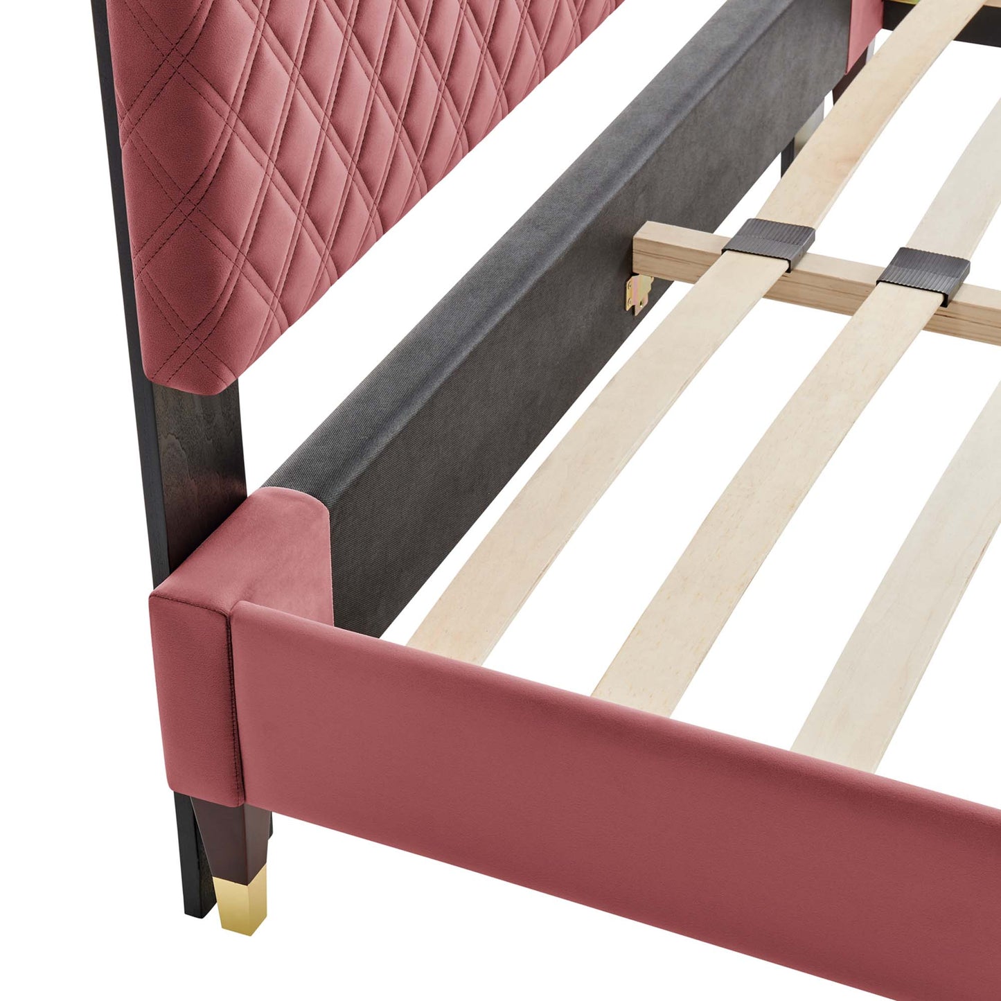 Pink quilted upholstered bed frame with headboard, light wooden slats, black metal supports, and gold cap feet.