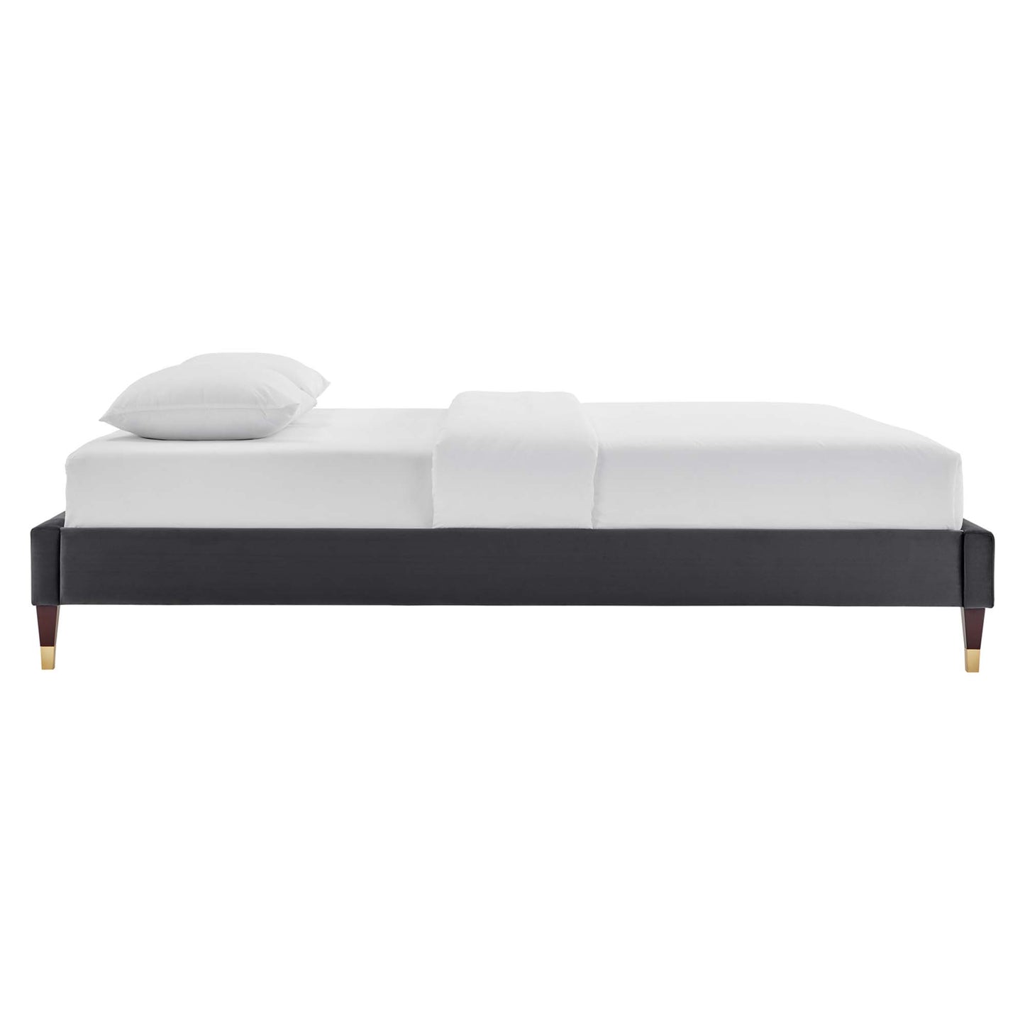 Charcoal gray upholstered platform bed with gold-tipped legs and white bedding.