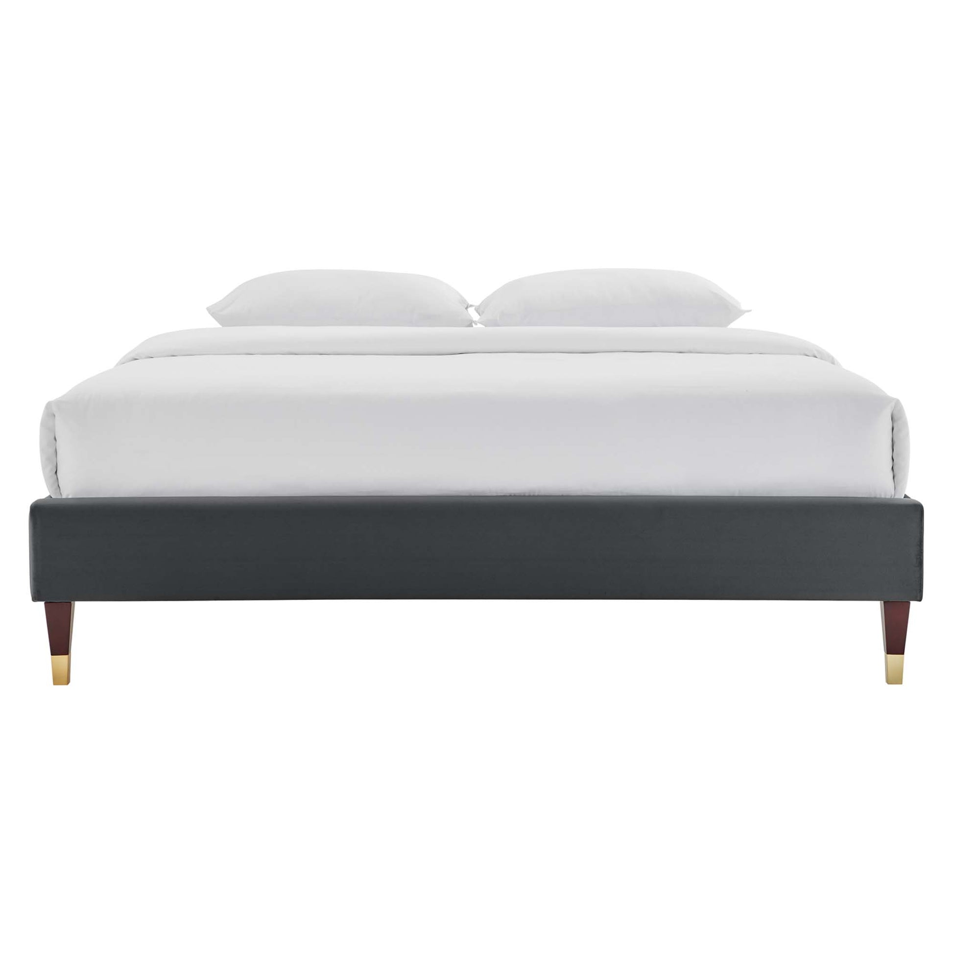 Charcoal velvet platform bed frame with gold-tipped legs and white bedding
