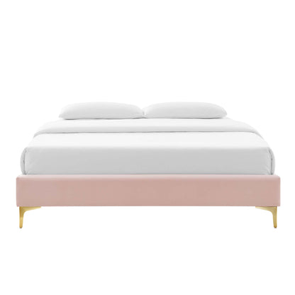 Low-profile red velvet upholstered platform bed frame with white bedding and gold legs.