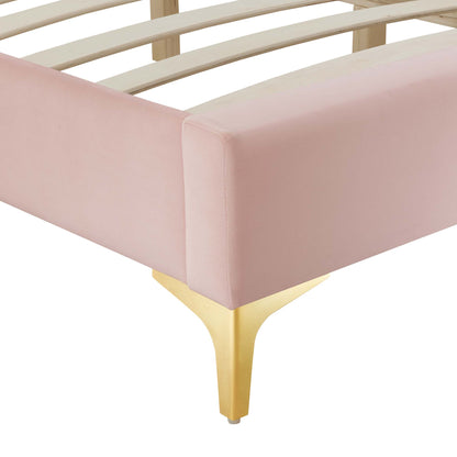 Red velvet upholstered platform bed frame with gold metal legs and slatted support.