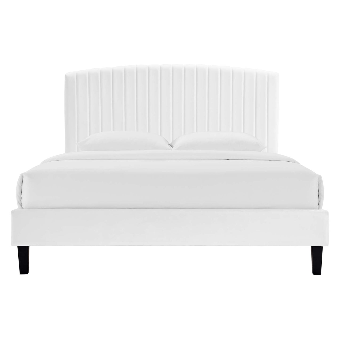 White upholstered platform bed with a tall vertical channel-tufted headboard, white bedding, and black legs.