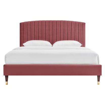 Burgundy upholstered platform bed with a tall vertical channel-tufted headboard, matching footboard, white bedding.