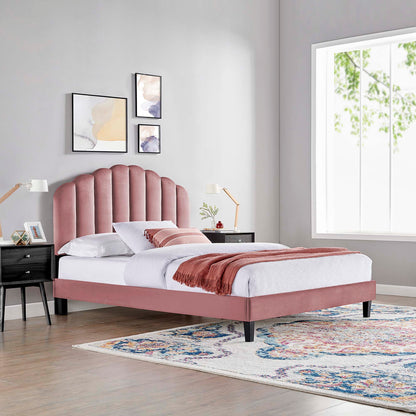 Red velvet queen platform bed with tufted curved headboard, white bedding, pink throw, black nightstands, gold lamps, rug