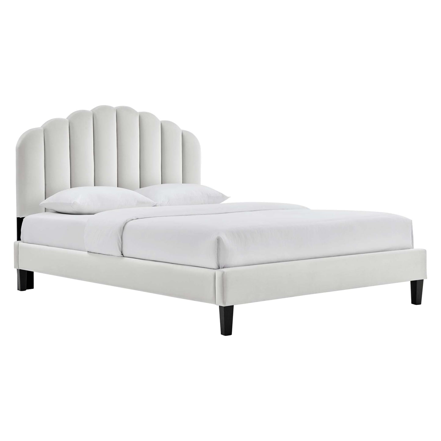 Light gray fabric upholstered bed with scalloped vertical-channel headboard, low platform frame and dark legs.