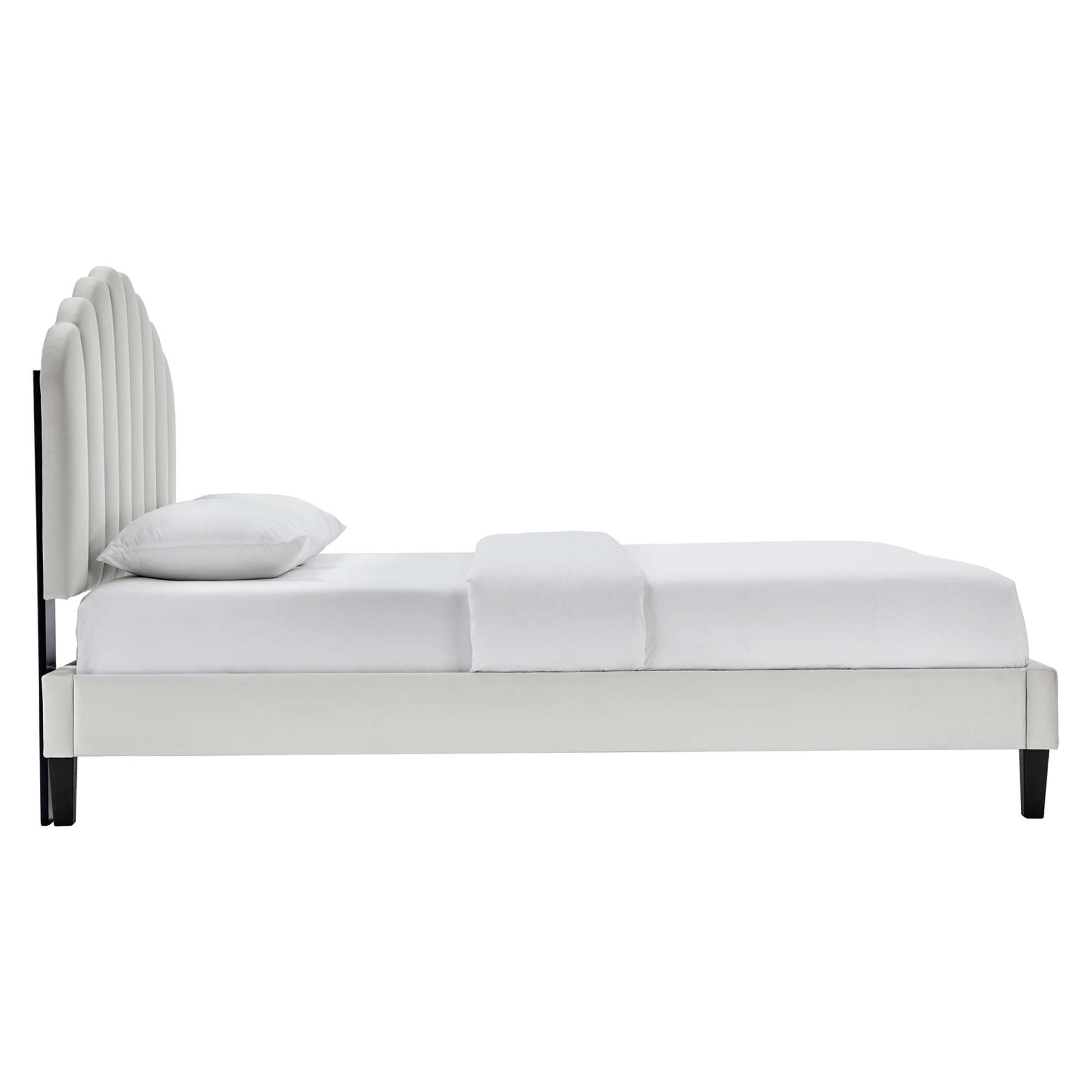 Gray velvet queen platform bed with curved, multi-panel headboard, clean modern design, white bedding, black legs.