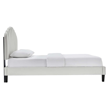 Gray velvet queen platform bed with curved, multi-panel headboard, clean modern design, white bedding, black legs.