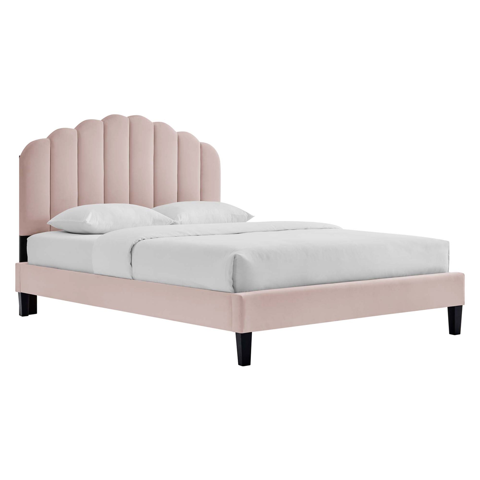 Pink velvet platform bed with scalloped vertical tufted headboard, white bedding, black legs.