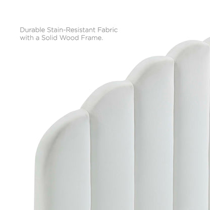 White upholstered headboard with curved vertical panels on a solid wood platform bed frame.