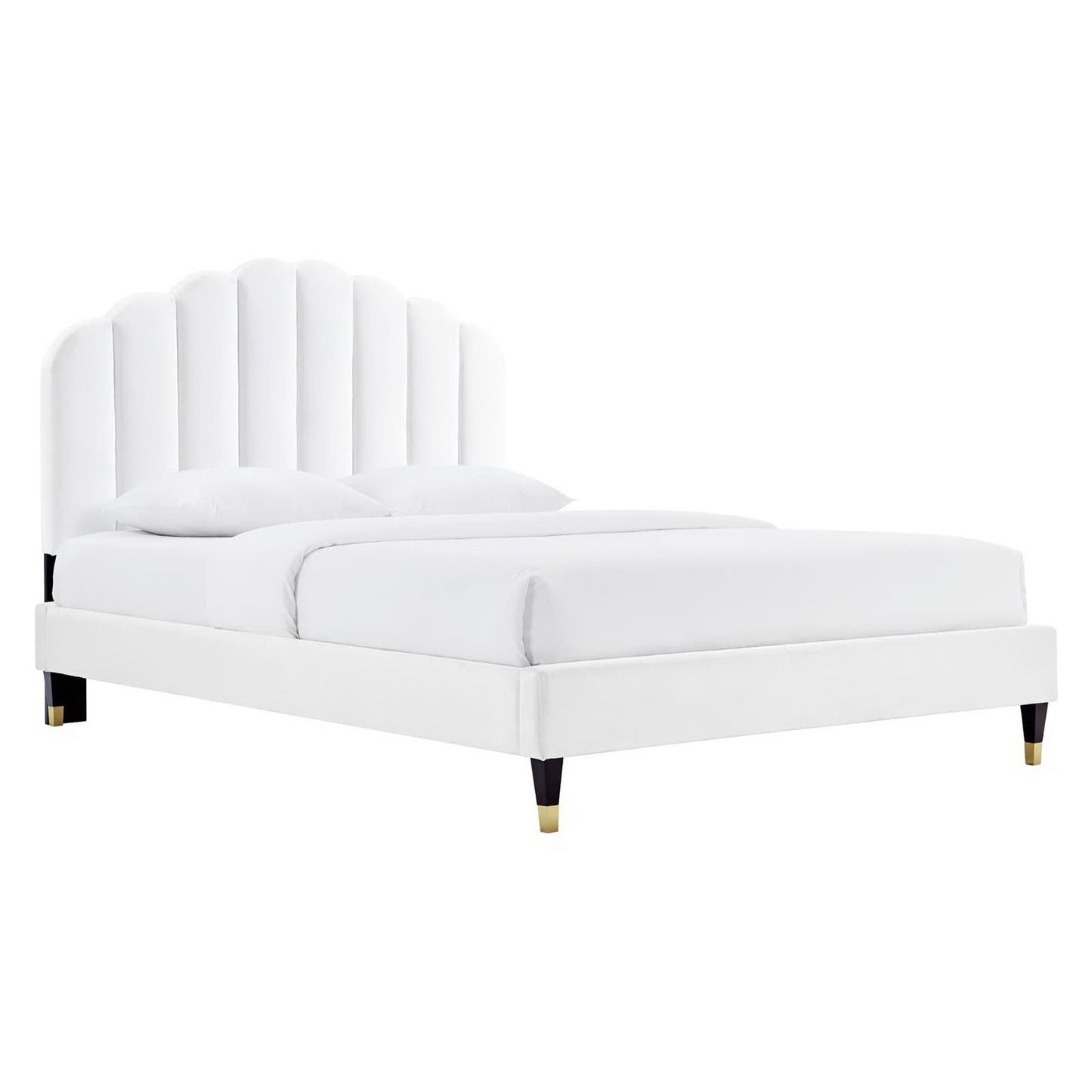 White upholstered bed with tall curved panel headboard, white bedding, and gold-tipped legs.