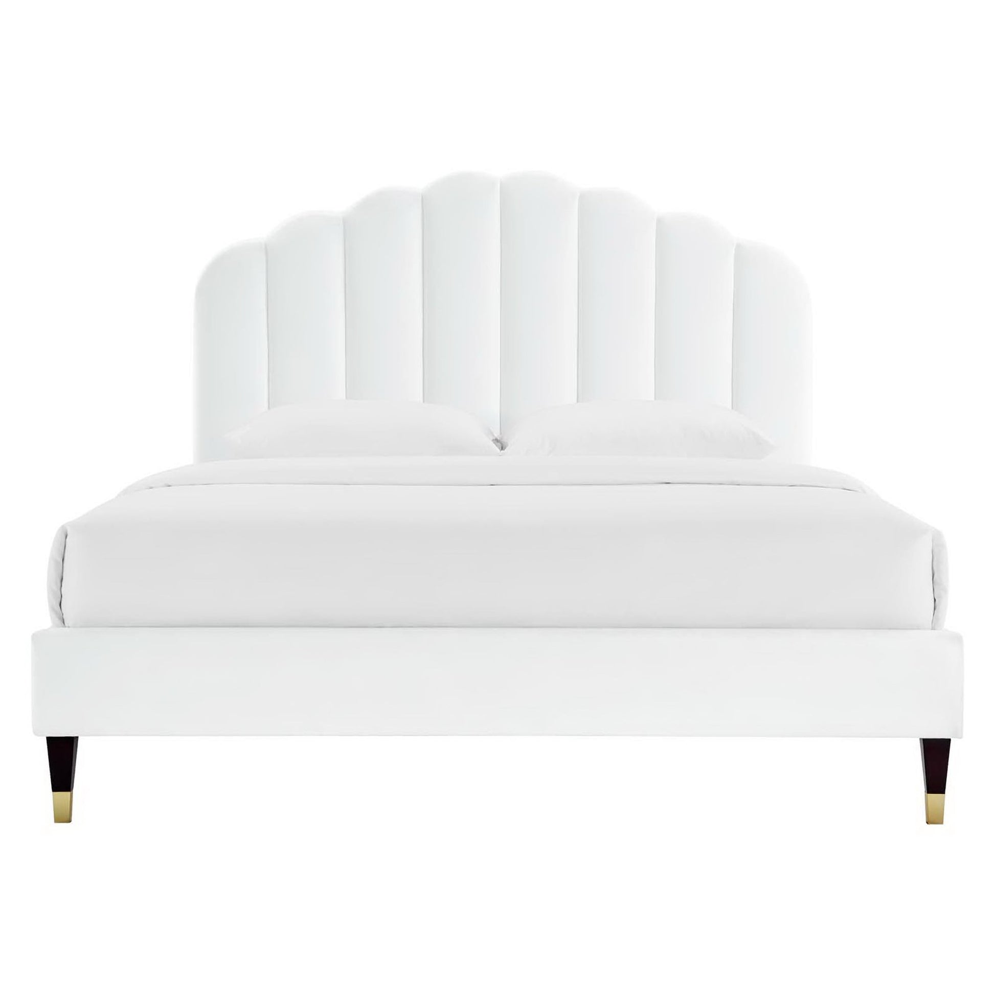 White upholstered platform bed with a tall scalloped shell headboard and gold-tipped legs.
