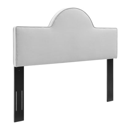 Light gray upholstered headboard with curved arch top and black metal legs for bed frame.