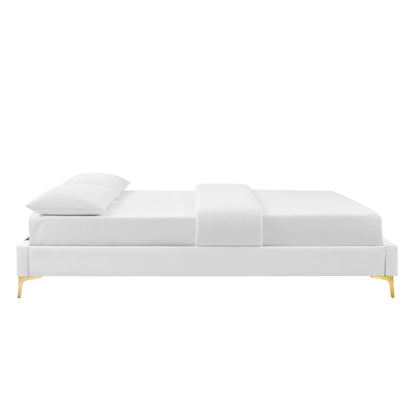 White full bed frame with slim gold legs, crisp bedding, two pillows on the left, modern & minimalist design.