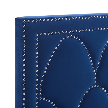 Navy velvet headboard panel with silver nailhead trim outlining geometric shapes.