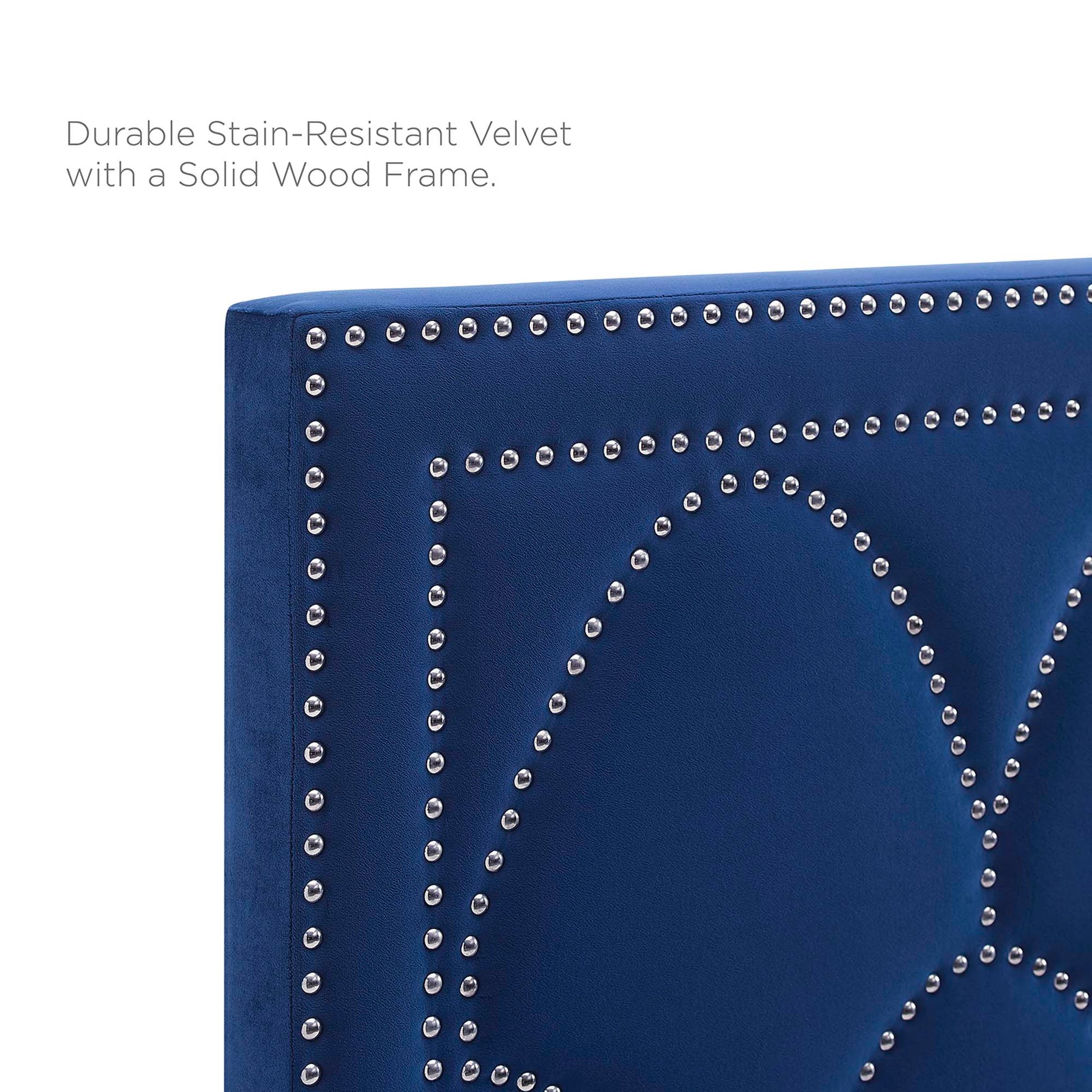 Navy blue velvet upholstered twin headboard with silver nailhead studs forming a geometric pattern; solid wood frame.