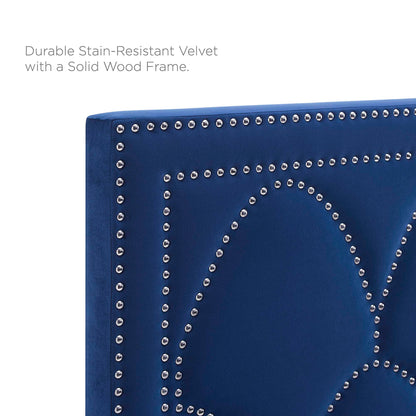 Navy blue velvet upholstered twin headboard with silver nailhead studs forming a geometric pattern; solid wood frame.